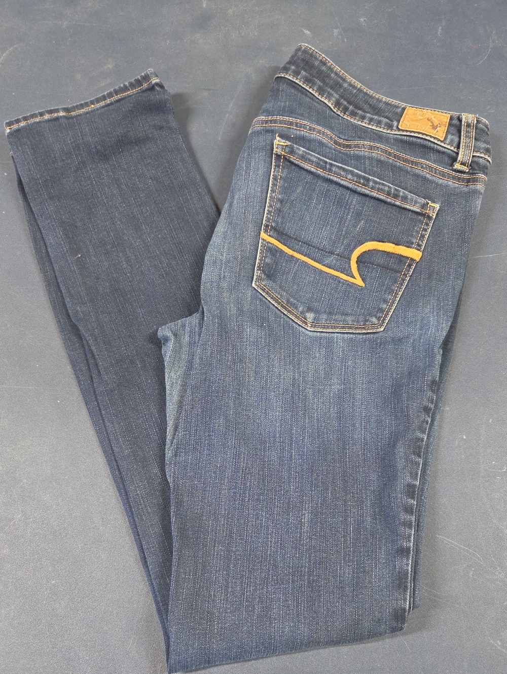 American Eagle Outfitters Dark Blue Skinny Jeans with Yellow Pocket Accent